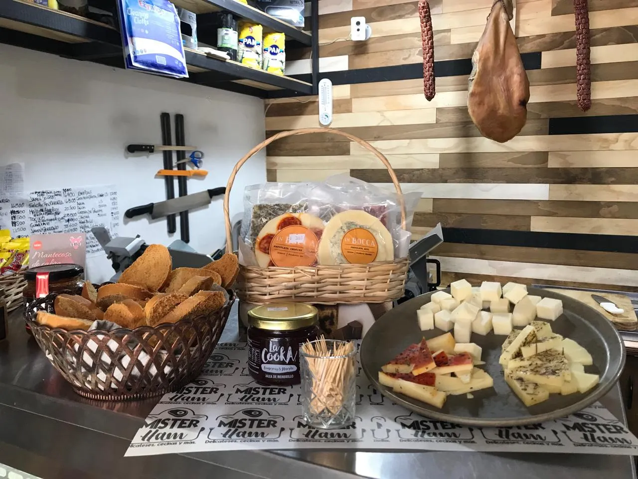 Mesa con quesos, pan y jamón